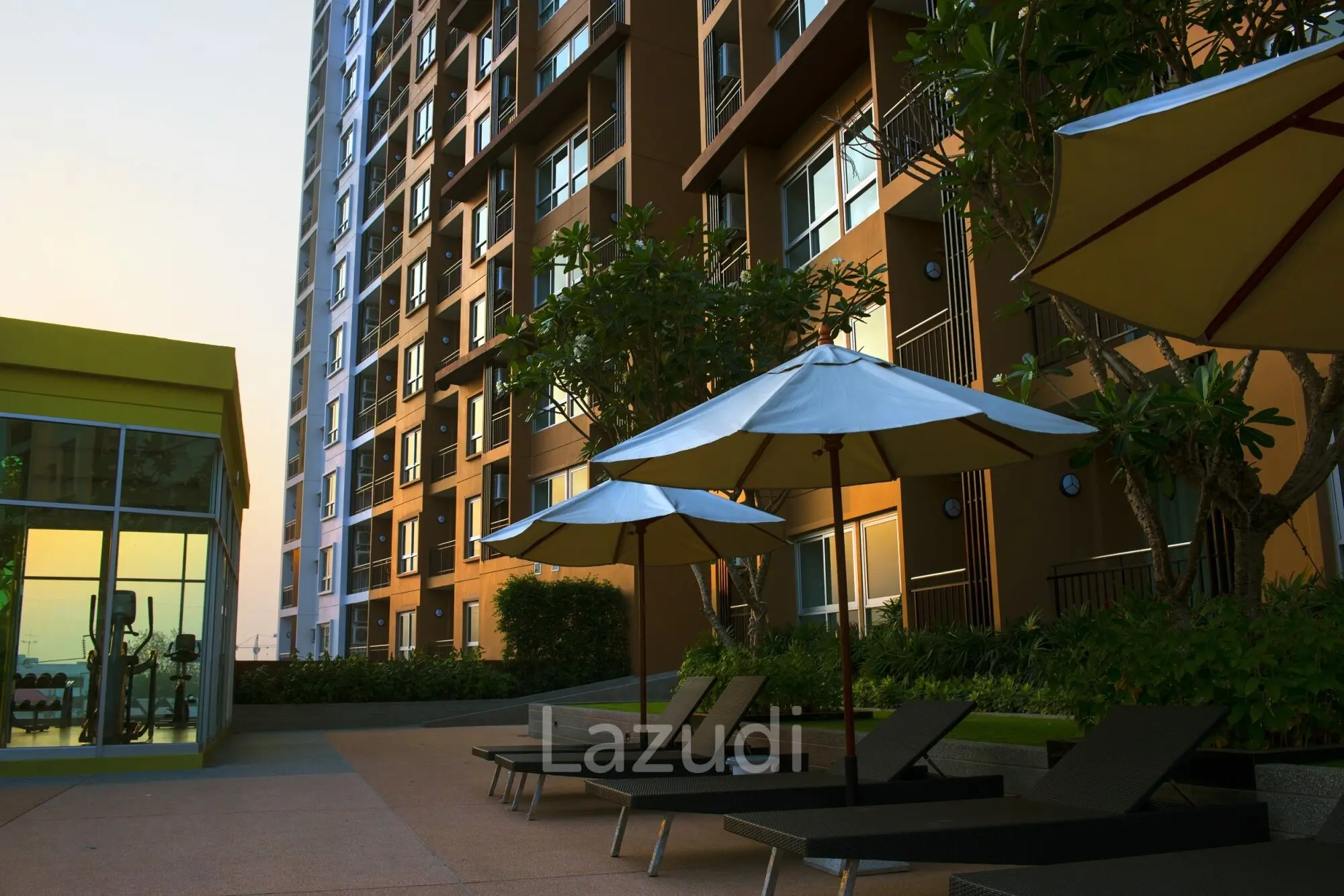 Rooftop pool deck with lounge chairs and stunning Chiang Mai mountain views at Supalai Monte 1